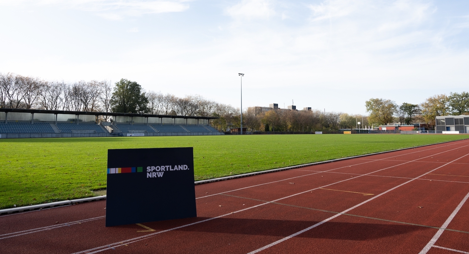 Sportland.NRW Schild auf einer Fußball Sportanlage mit Tartan-Laufbahn