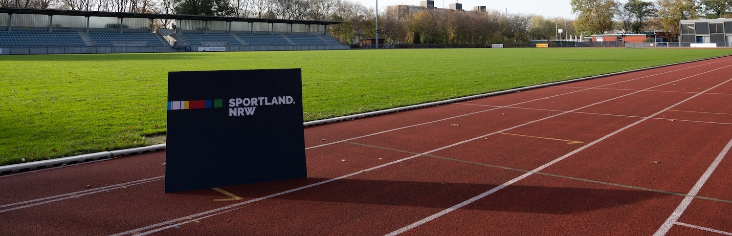 Sportland.NRW-Schild auf Tartanbahn